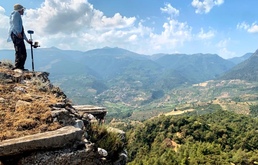 Benjamin Anderson, associate professor of history of art and visual studies, surveys the walls on the acropolis in Sardis, Turkey.