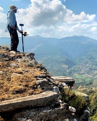 Benjamin Anderson, associate professor of history of art and visual studies, surveys the walls on the acropolis in Sardis, Turkey.
